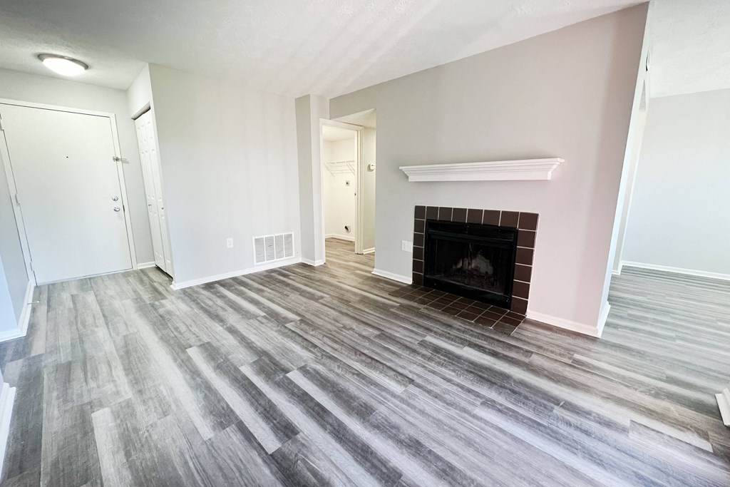 a living room with wood flooring and a fireplace  at Deercross Apartments, Cincinnati, 45236