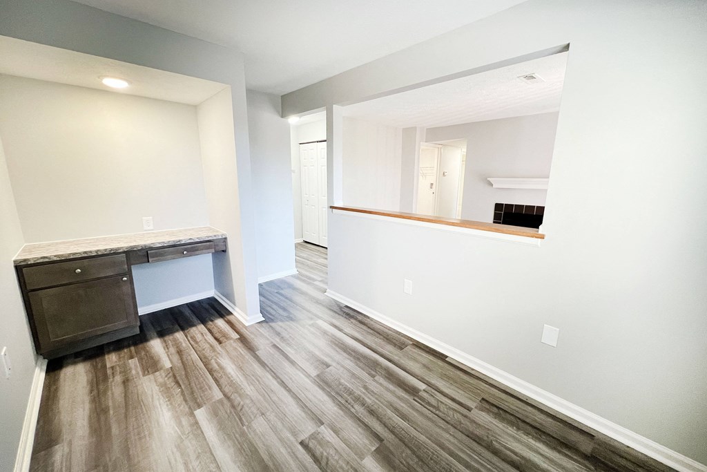an empty room with a desk and a mirror in a new home  at Deercross Apartments, Ohio