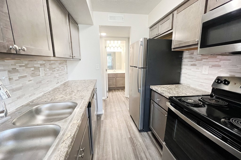 a kitchen with stainless steel appliances and marble counter tops  at Deercross Apartments, Ohio, 45236
