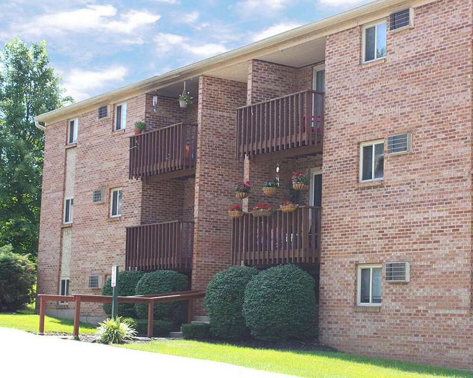 a red brick apartment building with balconies at Hunter Ridge Apartments, Cincinnati, OH