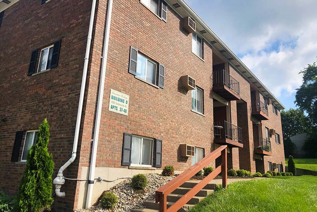 a brick building with a wooden fence in front of it at Hunter Ridge Apartments, Cincinnati, Ohio