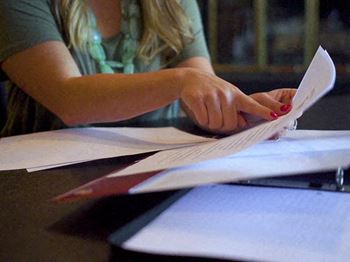 a woman cutting paper with a pair of scissors at Hunter Ridge Apartments, Cincinnati, OH