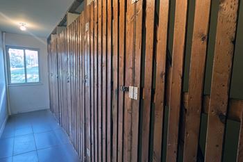 A room with wooden walls under construction.