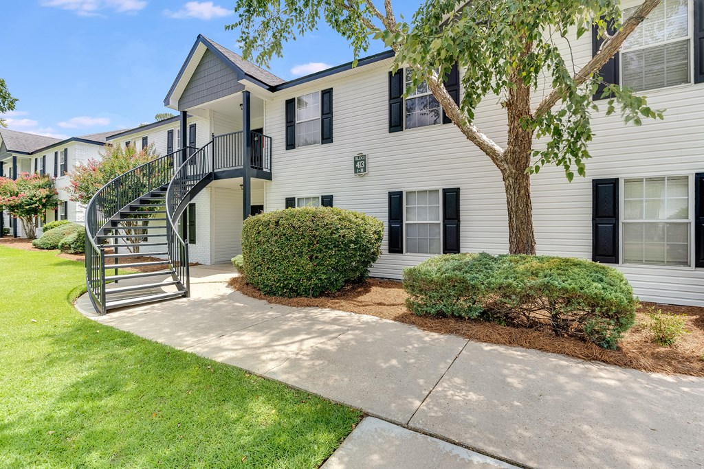 a white building with a spiral staircase in front of it at Dothan Farms, Dothan