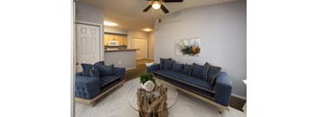 a living room with blue couches and a coffee table