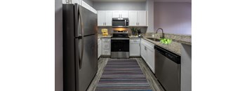 a kitchen with stainless steel appliances and granite counter tops