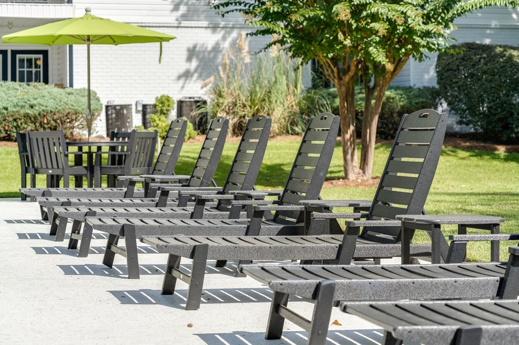 a row of wooden lounge chairs in a park at Dothan Farms, Dothan, Alabama