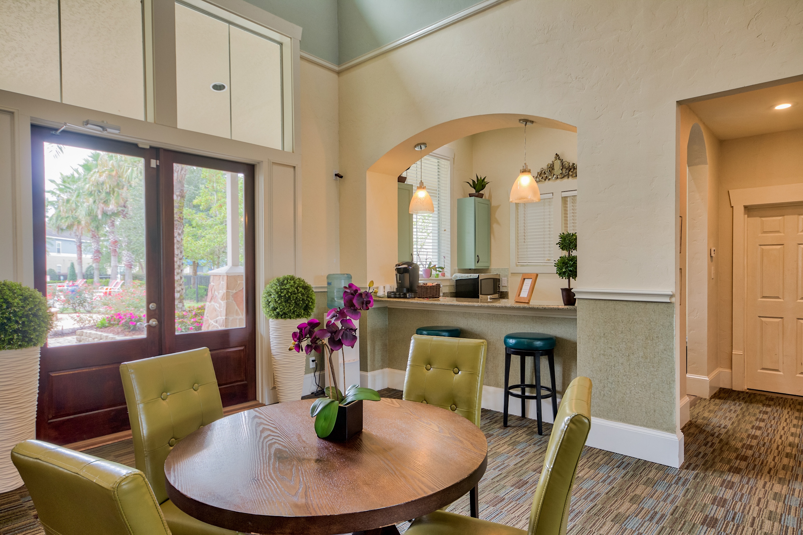 A dining room with a table and chairs.