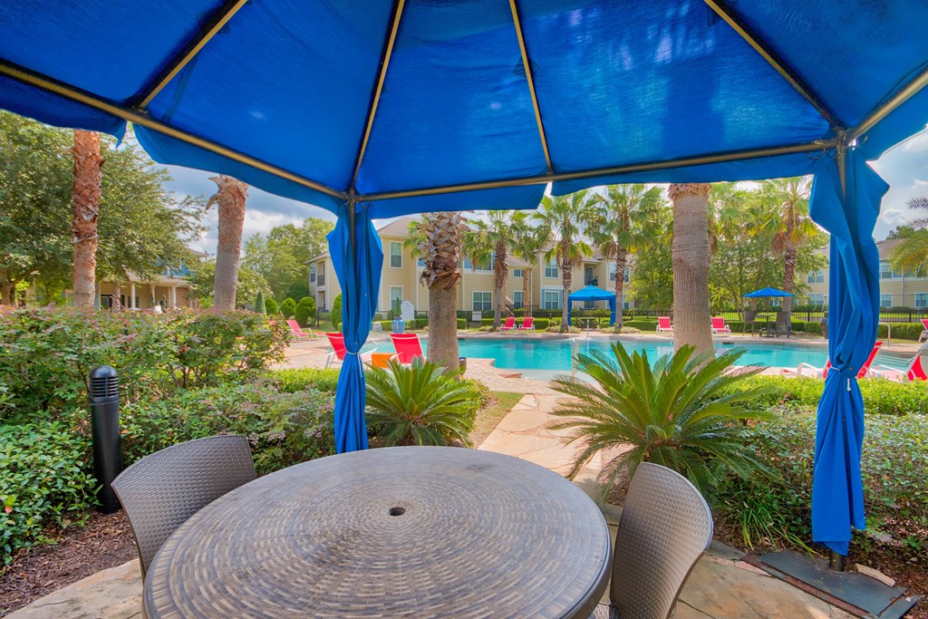A Blue Umbrella is Over a Table at Villas at Bon Secour Apartments, Gulf Shores, AL, 36542