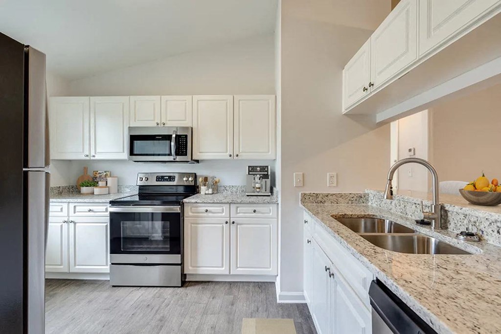 a kitchen with a stove top oven next to a sink at Dothan Farms, Dothan