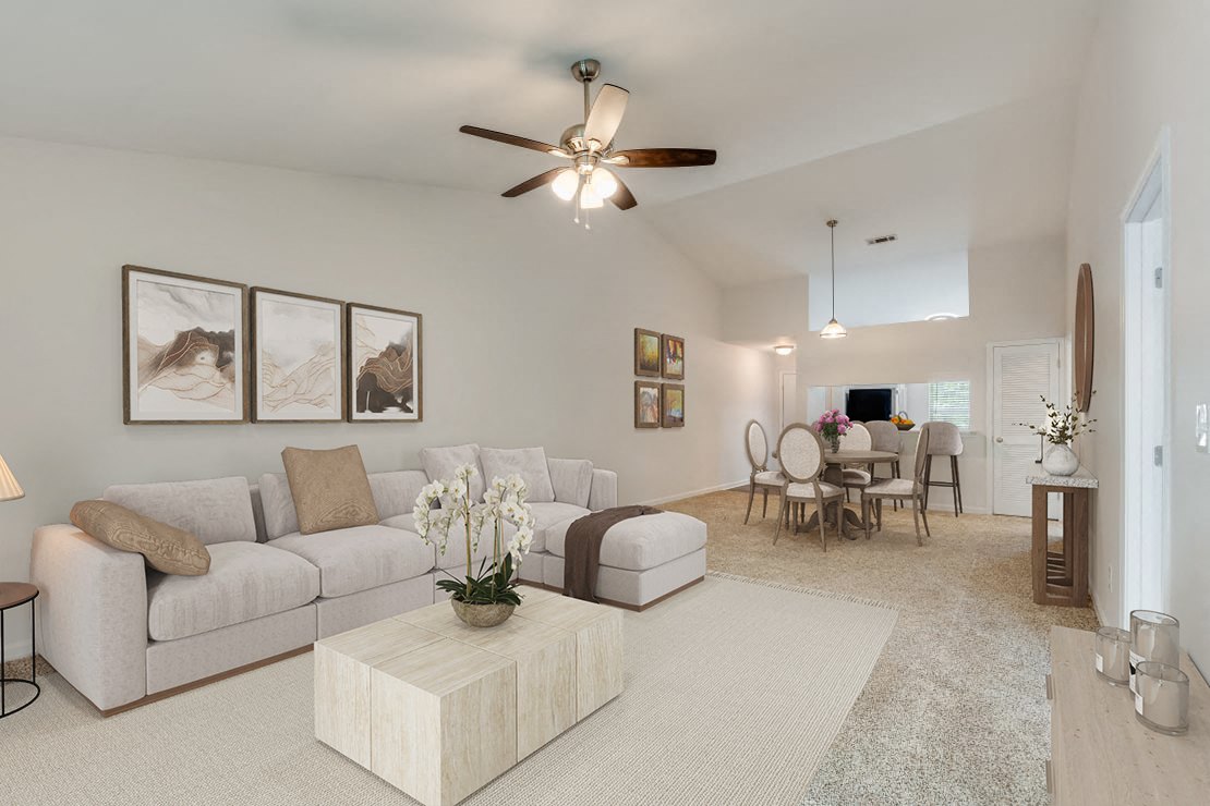 a living room with a couch and a ceiling fan