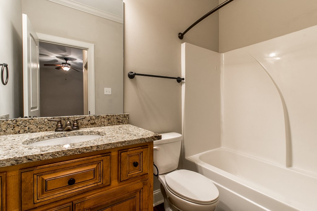 a bathroom with a sink toilet and a tub