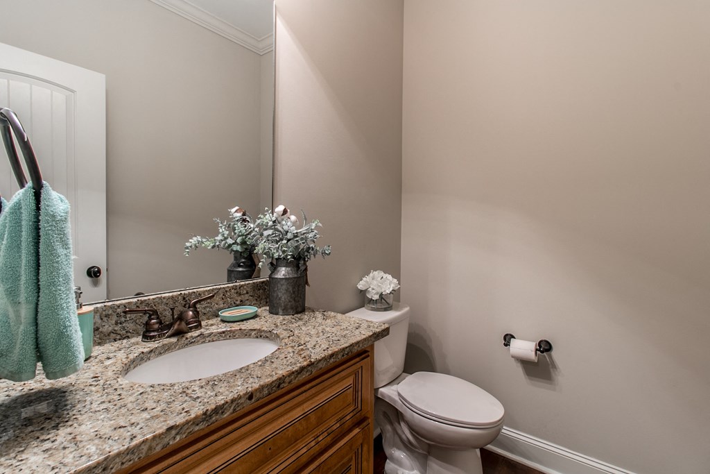 a bathroom with a toilet and a sink and a mirror