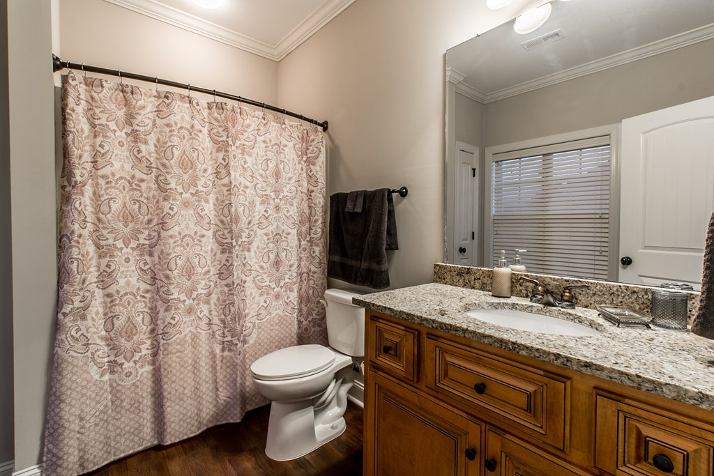 a bathroom with a toilet and a sink and a shower