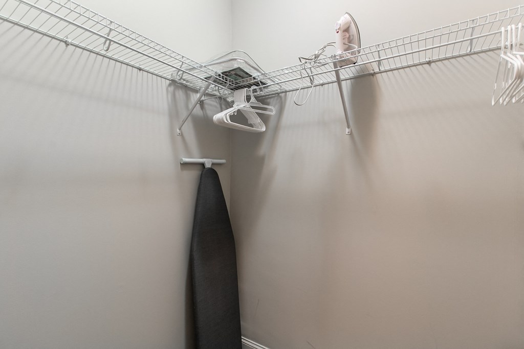 a woman in a wire closet with a surfboard on the wall