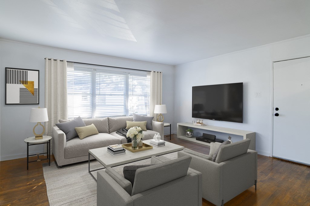 a living room with a couch and a coffee table a living room with a couch and a coffee table at Ann Street Lofts, Mobile, 36604