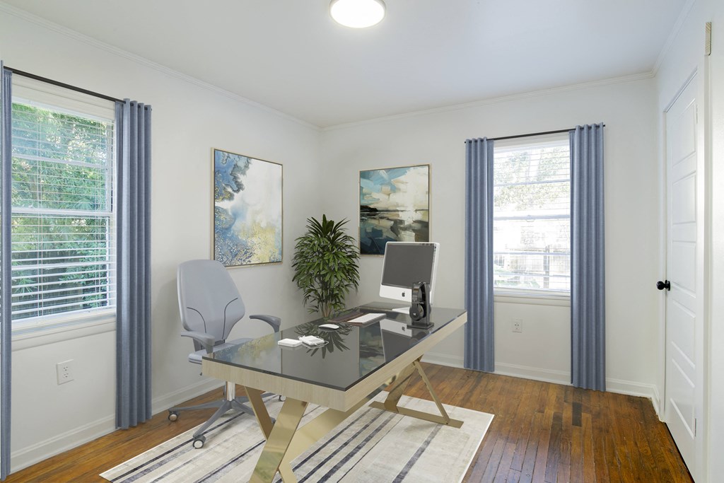 a home office with white walls and wood floors at Ann Street Lofts, Mobile, AL