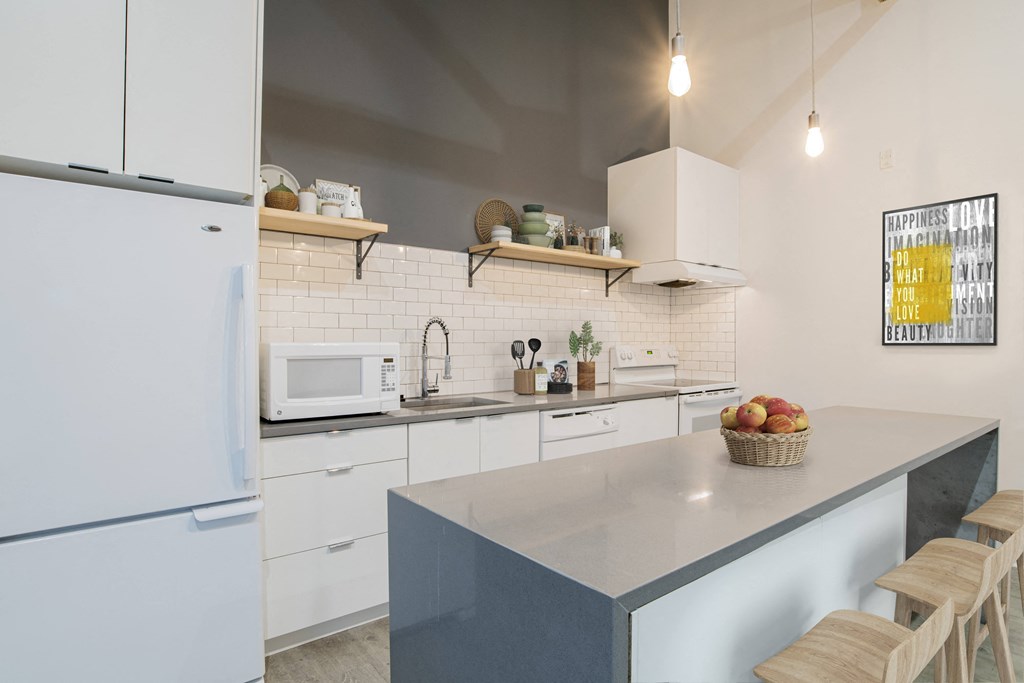a kitchen with white cabinets and a counter top