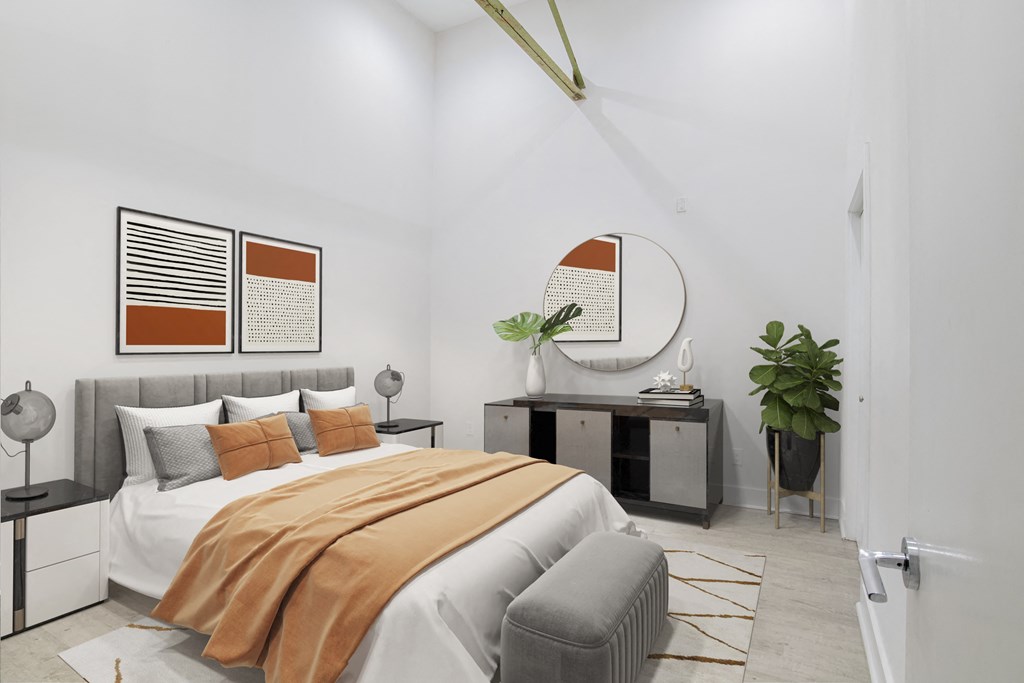 a bedroom with a large bed and a mirror