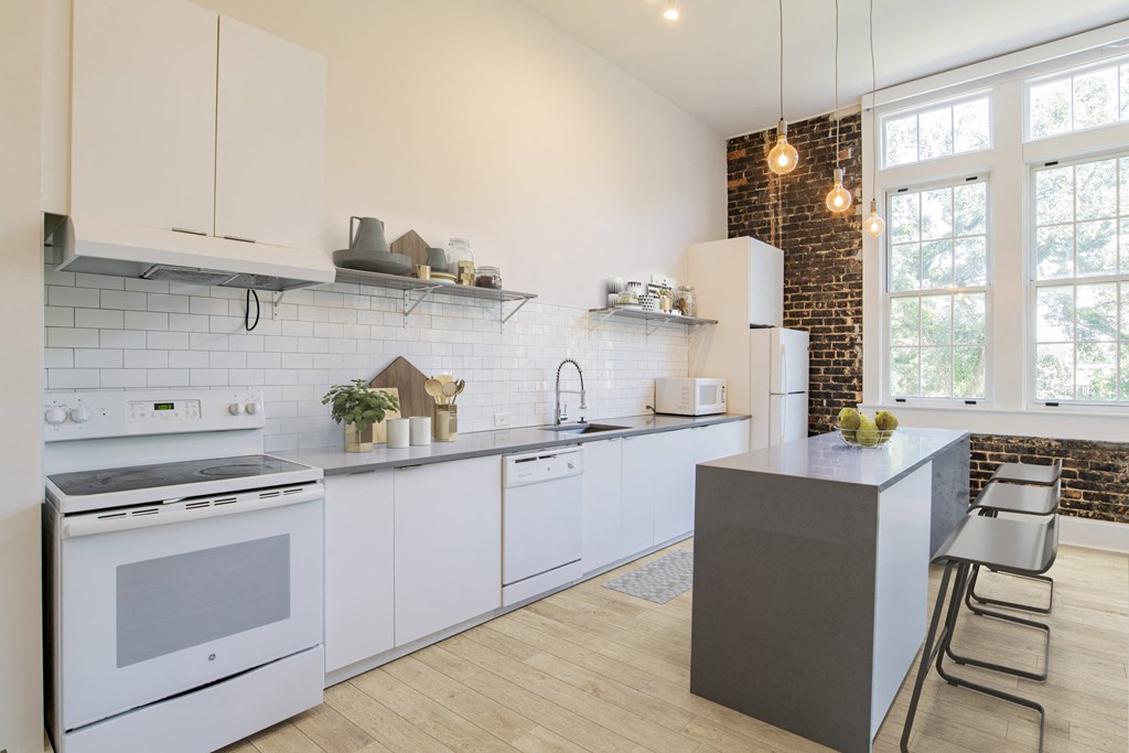 a white kitchen with white appliances and a counter top