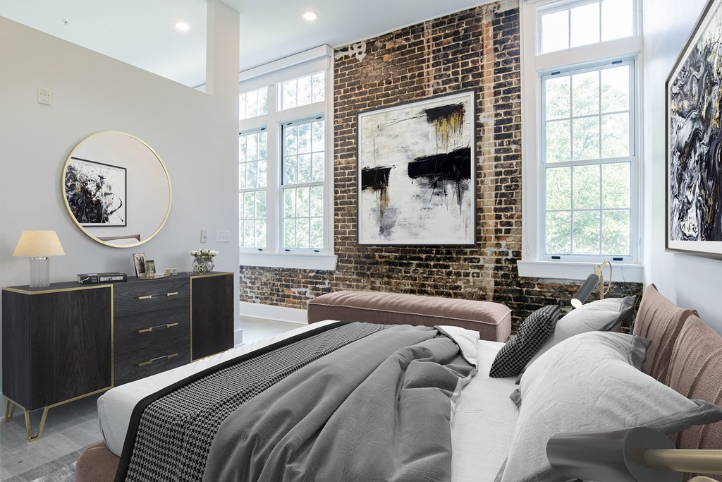a bedroom with a bed and a brick wall