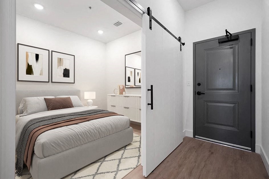 a bedroom with a bed and a black door