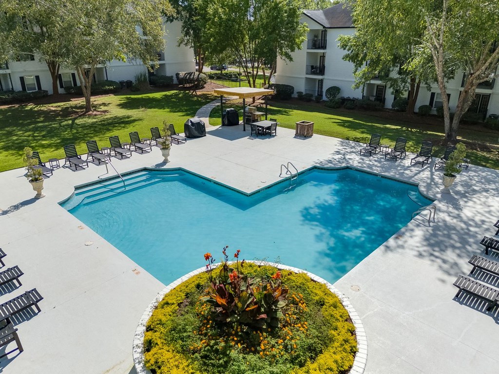 an aerial view of a swimming pool and patio with chairs and trees at Dothan Farms, Dothan, AL