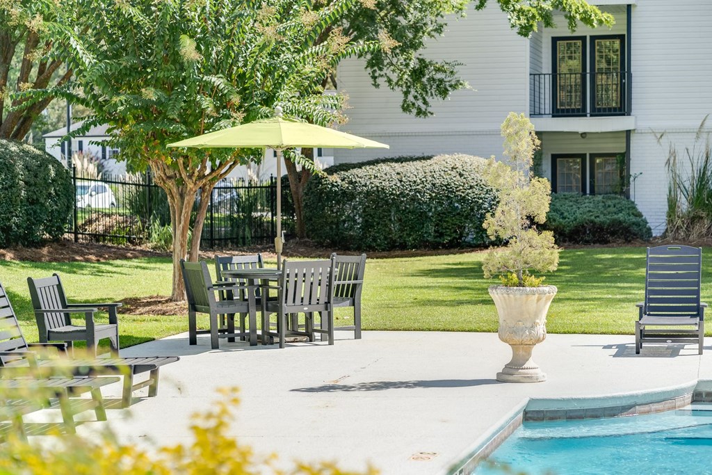 a patio with a table and chairs next to a swimming pool at Dothan Farms, Alabama, 36305