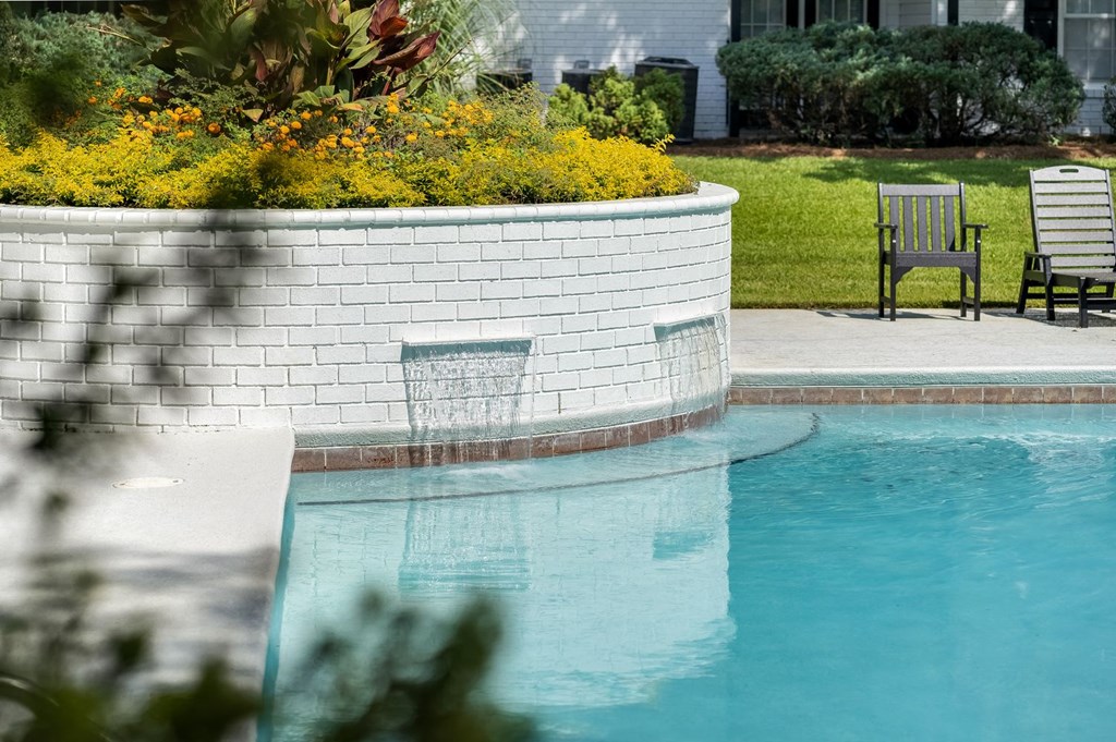 a swimming pool in a backyard with a patio and chairs at Dothan Farms, Dothan, Alabama