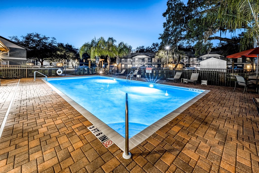 a swimming pool with blue water in a resort style pool