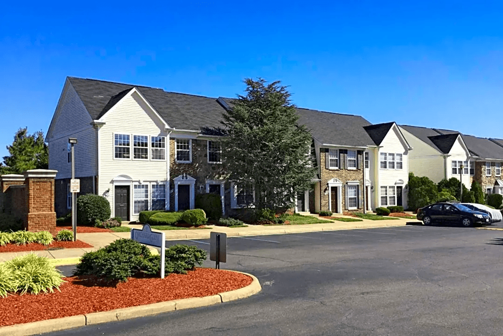a row of houses on a street with a parking lot