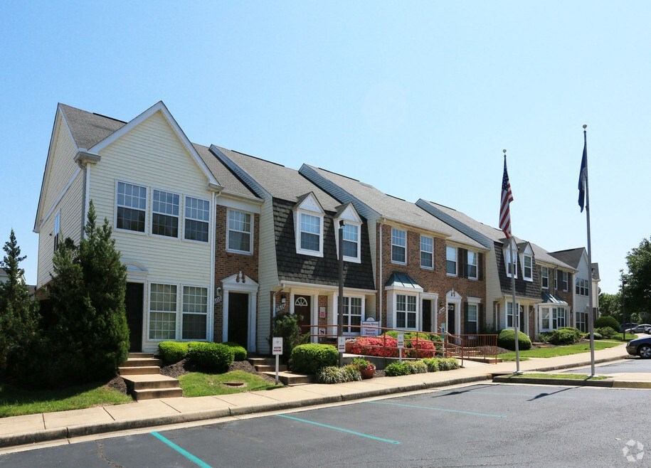 a row of town homes on a street with an flag