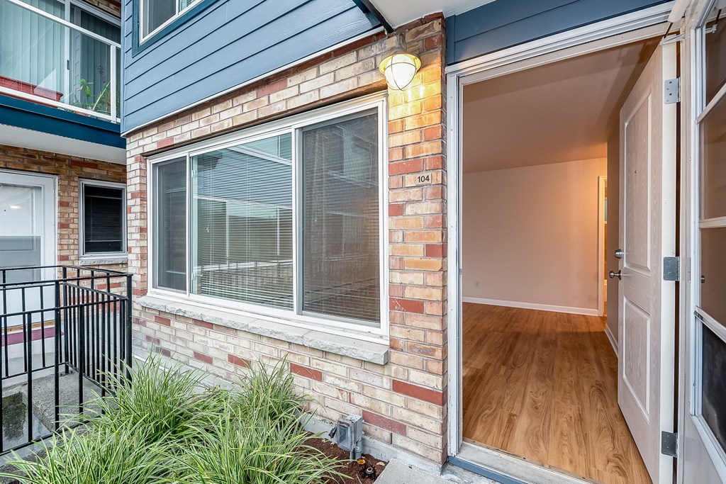 the entrance to a brick house with a glass door