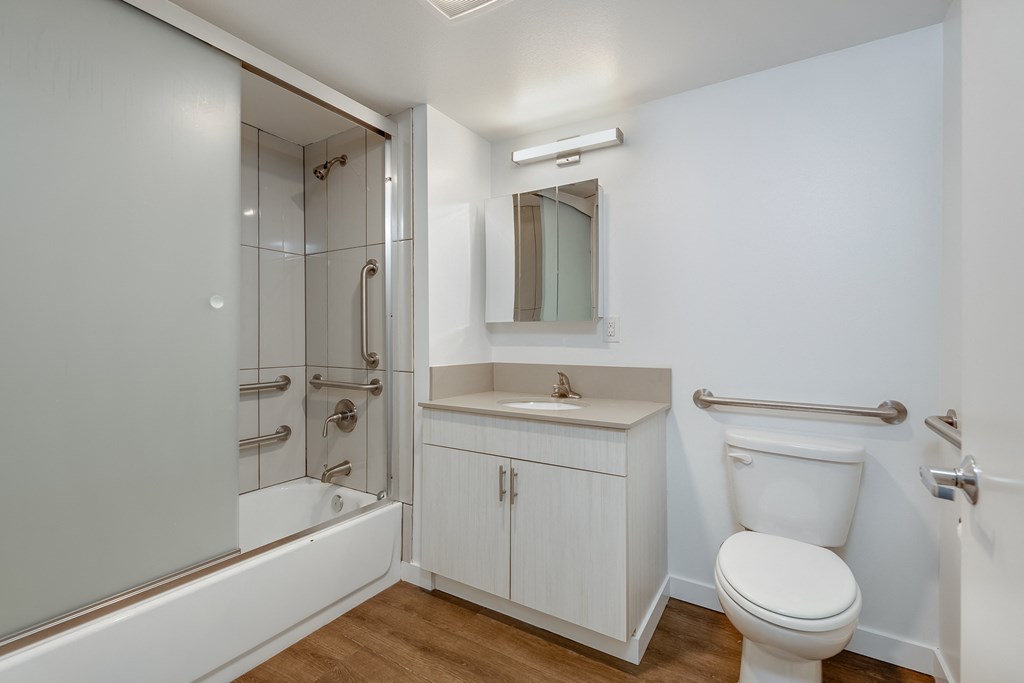 a bathroom with a toilet sink and shower