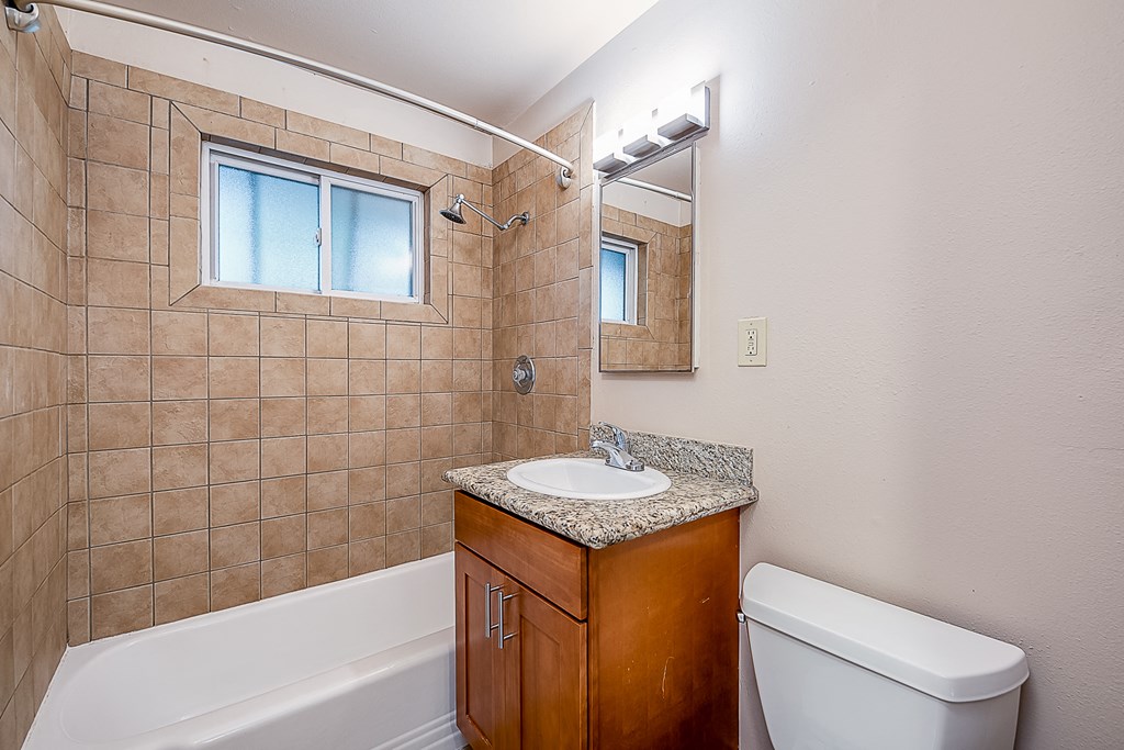 a bathroom with a sink toilet and a bath tub