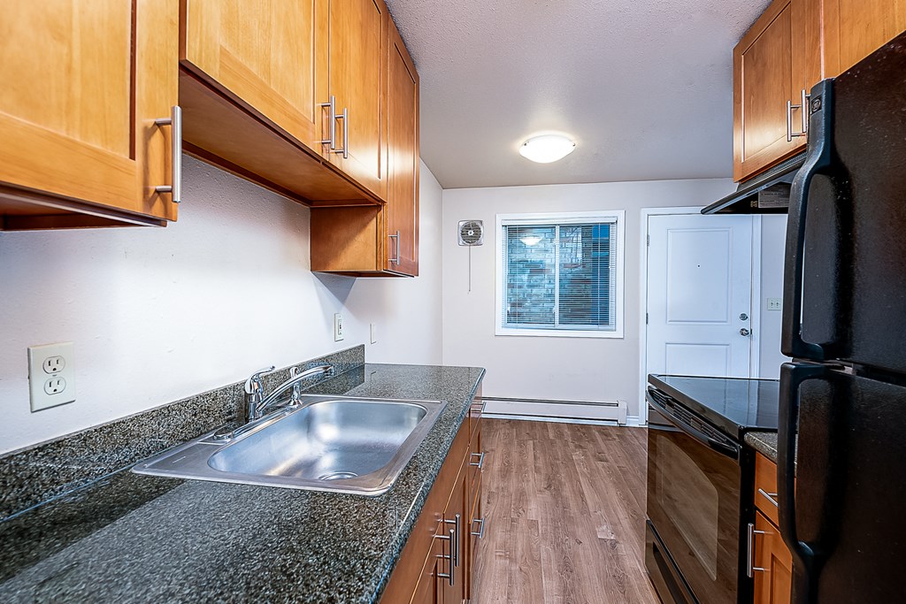 a kitchen with wooden cabinets and a sink