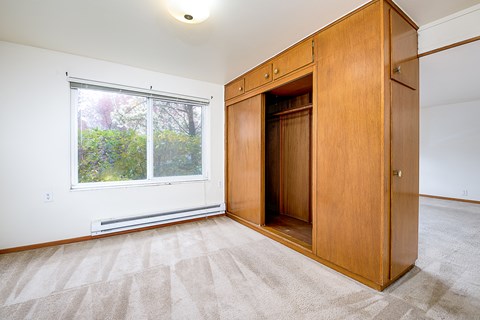 a bedroom with a wardrobe and a window
