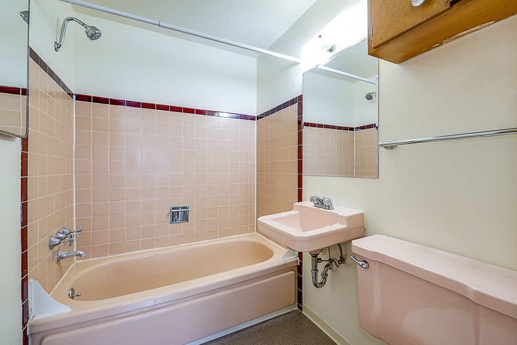 a bathroom with a tub sink and a toilet