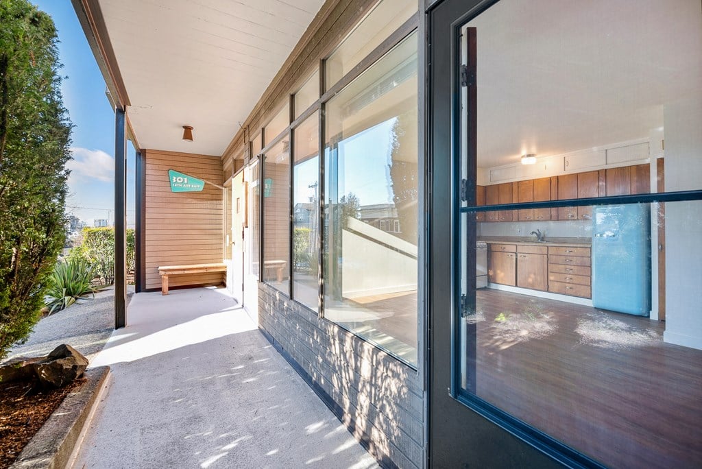 the entrance to a building with large glass windows and a walkway