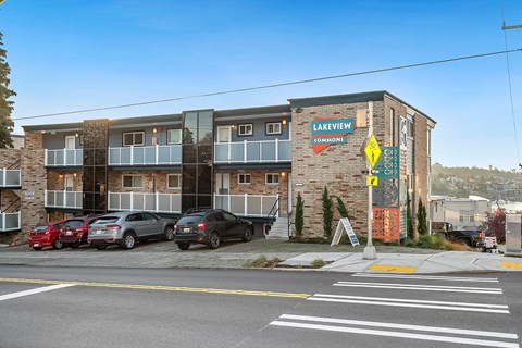 an apartment building with cars parked in front of it