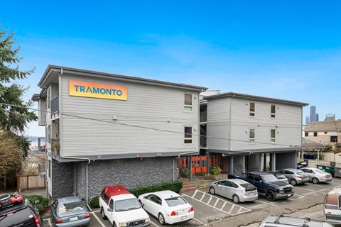 the front of a building with cars parked in a parking lot