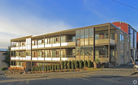 a large apartment building on the side of a street