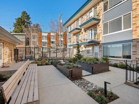 a yard with a wooden bench in front of a building