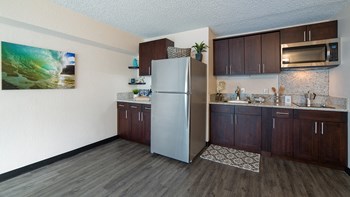 Waikiki Walina Apartments kitchen area with appliances, counters, and cabinets