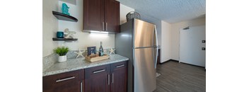 Waikiki Walina Apartments entry way and kitchen area with appliances, cabinets, and counters