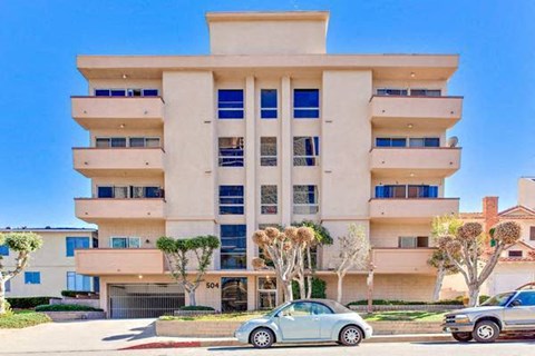 A modern building with a car parked in front.