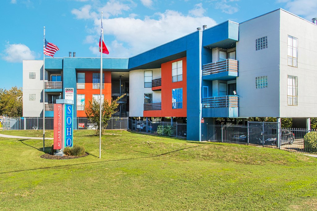 a blue and red building with flags in front of it