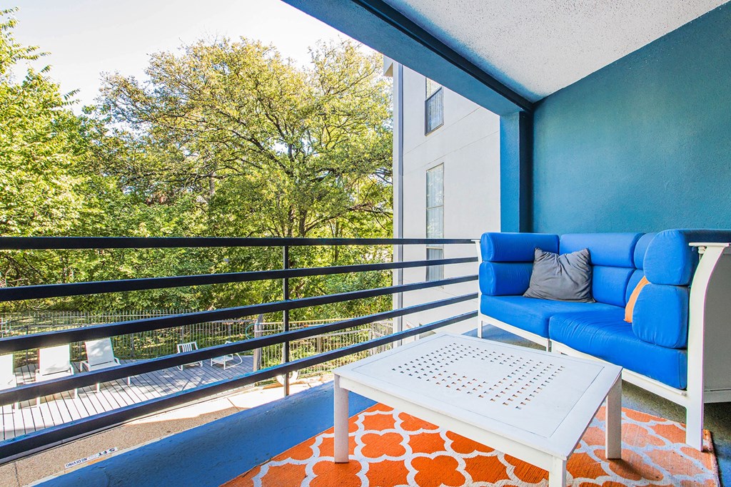 a living room with a blue couch and a coffee table