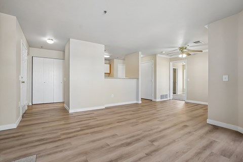 Pines at Castle Rock 2728 living room with wooden flooring and white walls.