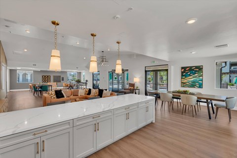 A modern kitchen with white cabinets and a long island.